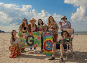 Members of the Sina Ghaemmaghami laboratory gathered on a beach with colorful decorations.